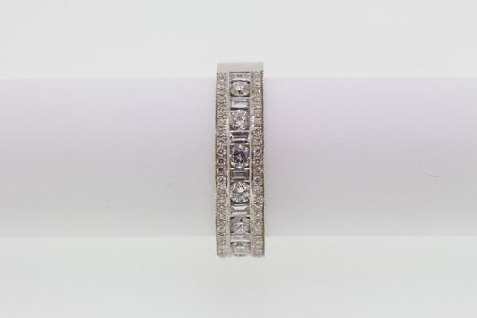 Channel Set Diamond Ring; channel set brilliant and baguette-cut diamonds flanked by rows of pave-set diamonds, 1.00 carat total, in 18ct white gold