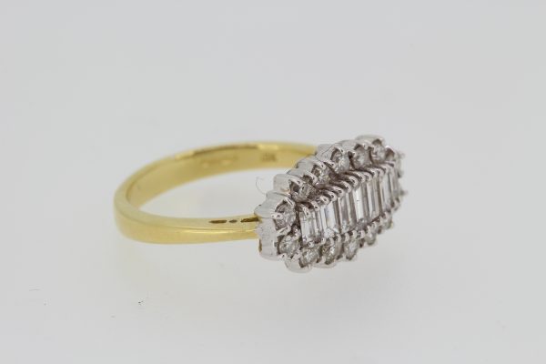 Baguette Cut Diamond Cluster Ring; central row of graduated baguette-cut diamonds within a round brilliant-cut diamond surround, 1.00 carat total, 18ct yellow gold