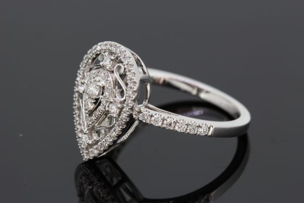 Pear Shaped Diamond Cluster Dress Ring, 0.41 carats, two central round brilliant-cut diamonds within pear-shaped diamond border, surrounded by white gold scrolls with diamond accents, all within an outer pear-shaped diamond-set halo, in 18ct white gold with diamond set shoulders