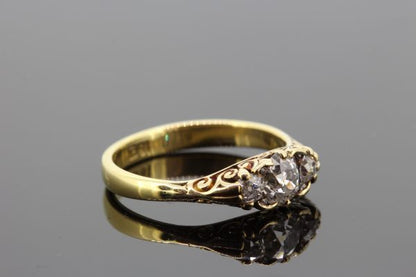 Antique Victorian Old Cut Diamond Three Stone Ring; featuring three old cut diamonds mounted in 18ct yellow gold with pierced under-gallery