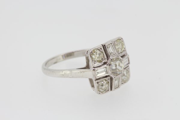 Old Cut Diamond Cluster Ring; square shaped head with central old cut diamond surrounded by four old-cut diamonds alternated with baguette-cut diamonds, in 18ct white gold