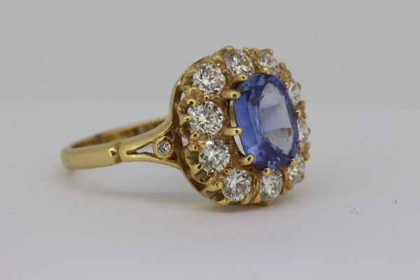 Victorian Style Sapphire and Old Cut Diamond Cluster Ring; central 1.90ct oval faceted sapphire set within 1.50ct old-cut diamond surround, in 18ct yellow gold