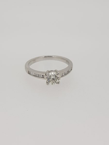 Diamond Solitaire Engagement Ring with Princess Cut Diamond Shoulders; central 0.85ct round brilliant-cut diamond, claw-set, flanked by 0.42cts channel-set princess-cut diamond set shoulders, in 18ct white gold