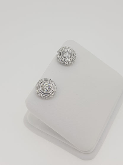A pair of diamond round cluster earrings in white gold