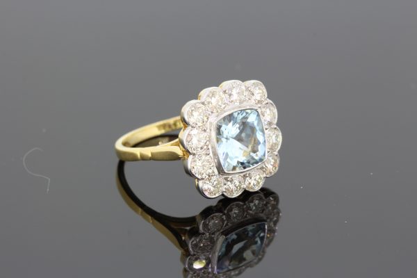 Aquamarine and Diamond Floral Cluster Ring; central 1.35ct square cushion-shaped aquamarine surrounded by 1.25cts diamonds, in 18ct gold