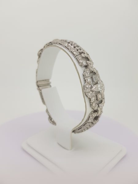 Vintage Geometric Diamond Bracelet in Platinum; central marquise cut diamond set within an open panel border decorated with baguette-cut and round brilliant-cut diamonds, Circa 1960s.