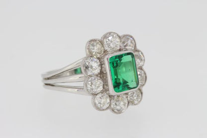 Colombian Emerald and Old Cut Diamond Cluster Ring; a fine 2.20ct Colombian emerald with minor oil surrounded by 2cts old-cut diamonds, in 18ct white gold
