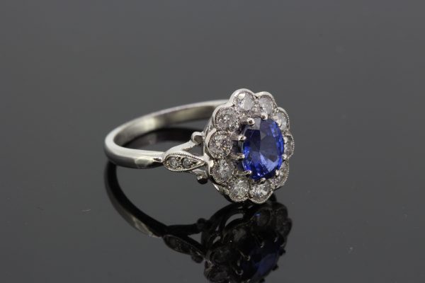 Sapphire and Diamond Oval Cluster Ring in Platinum; featuring a 1.65ct oval sapphire within a 0.85ct diamond surround