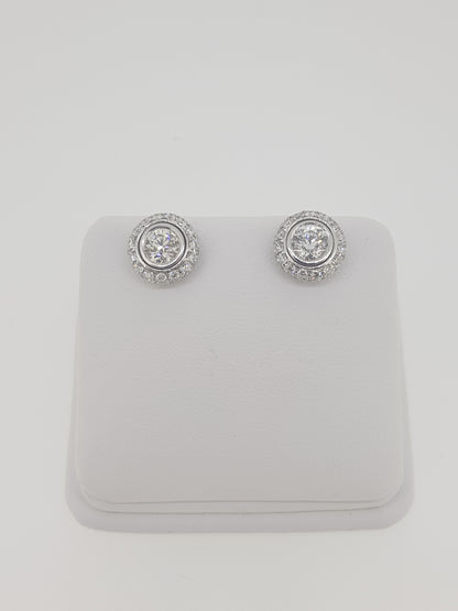 A pair of diamond round cluster earrings in white gold
