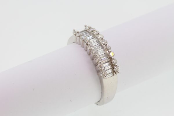 Channel Set Baguette Cut Diamond Ring; central row of channel-set baguette-cut diamonds flanked either side by a row of brilliant-cut diamonds, 1.66 carat total, in 18ct white gold