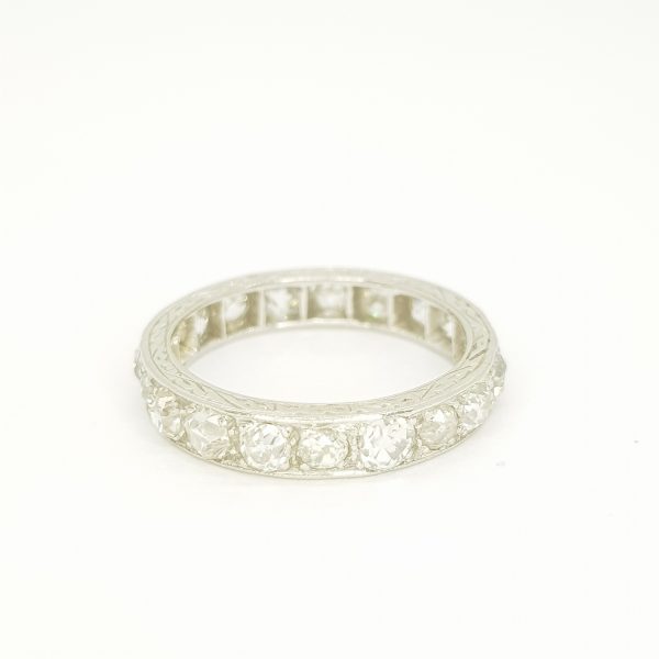 Vintage Old Cut Diamond Full Eternity Ring in Platinum, set with 1.50 carats of old cut diamonds and accented with engraved edges, Circa 1920