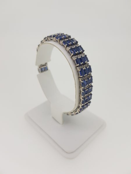Oval Cut Sapphire and Diamond Bracelet; comprising of three rows of alternated 12.00cts oval faceted sapphires and 1.80cts diamonds, in 14ct gold