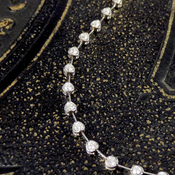 Diamond spacer line necklace in white gold.