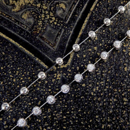 Diamond spacer line necklace in white gold.