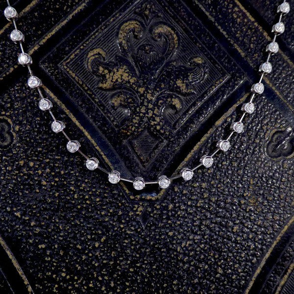 Diamond spacer line necklace in white gold.