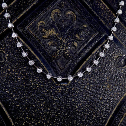 Diamond spacer line necklace in white gold.