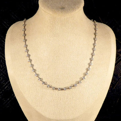 Diamond spacer line necklace in white gold.