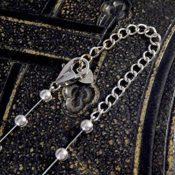 Diamond spacer line necklace in white gold.