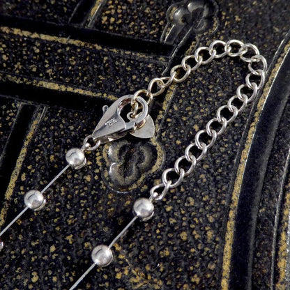 Diamond spacer line necklace in white gold.