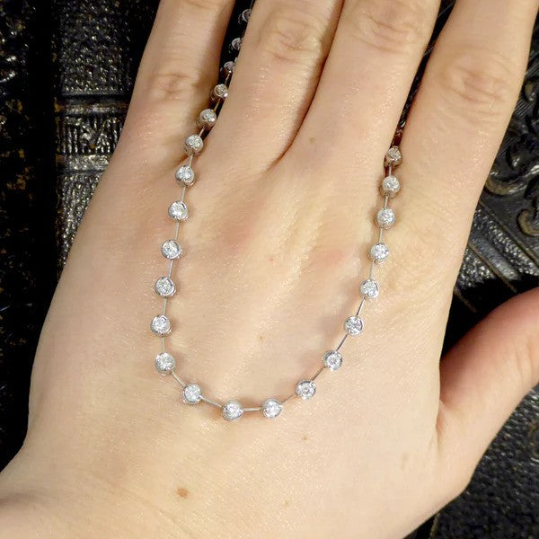 Diamond spacer line necklace in white gold.