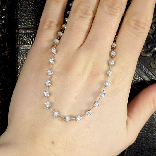 Diamond spacer line necklace in white gold.