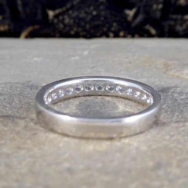 Platinum half eternity ring with diamonds.