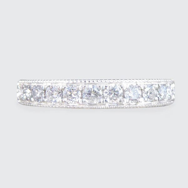 Platinum half eternity ring with diamonds.