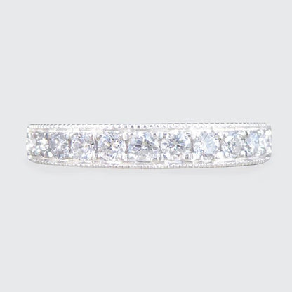 Platinum half eternity ring with diamonds.