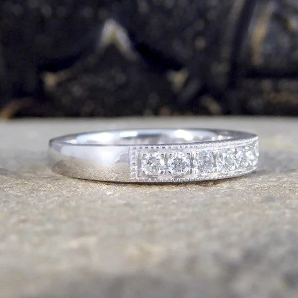 Platinum half eternity ring with diamonds.