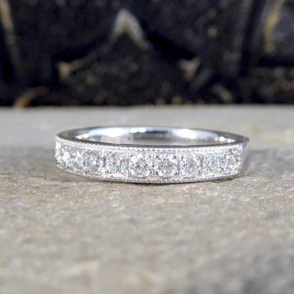 Platinum half eternity ring with diamonds.