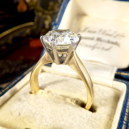 Solitaire diamond engagement ring in white and yellow gold.