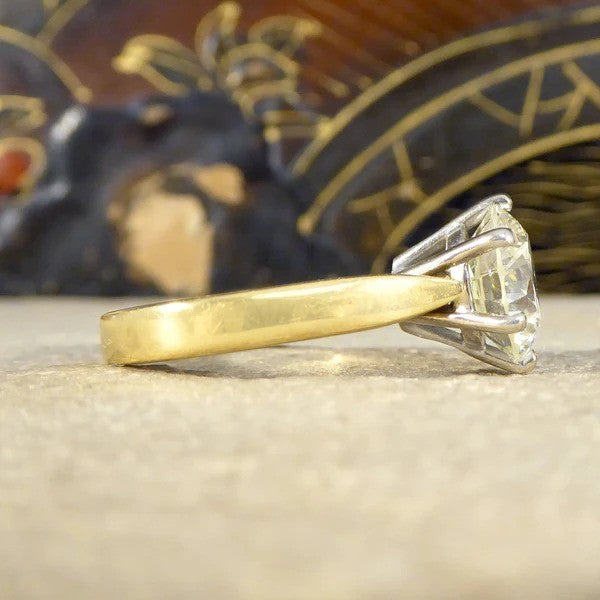 Solitaire diamond engagement ring in white and yellow gold.