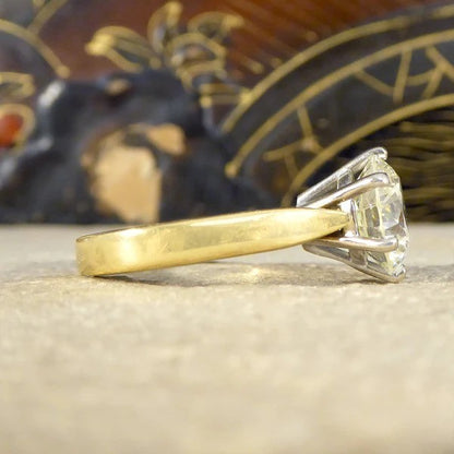 Solitaire diamond engagement ring in white and yellow gold.