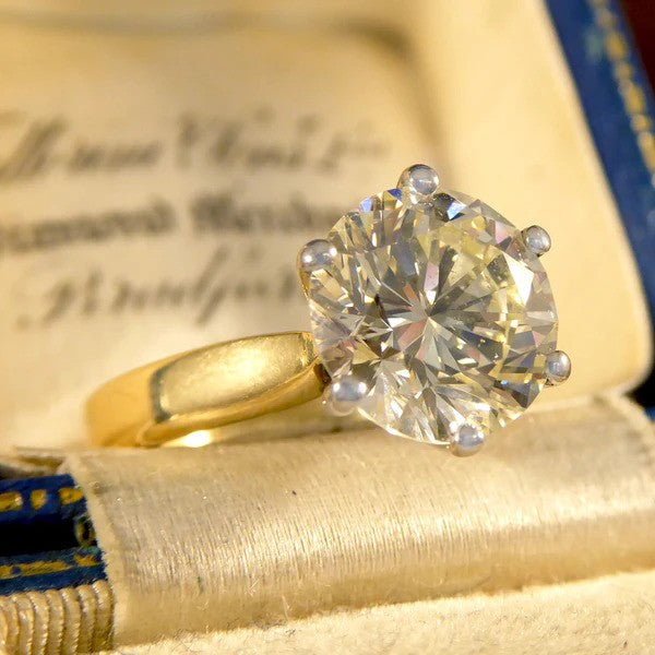 Solitaire diamond engagement ring in white and yellow gold.