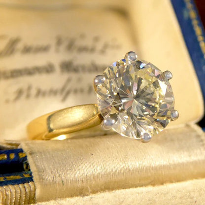 Solitaire diamond engagement ring in white and yellow gold.