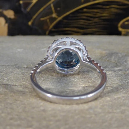 Halo cluster ring with London blue topaz and diamonds set in platinum.