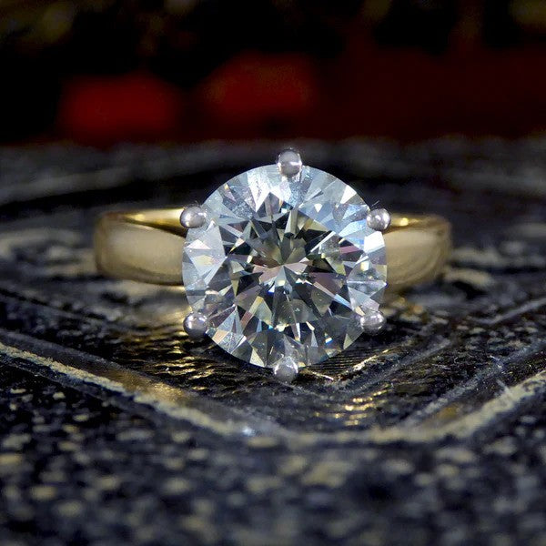 Solitaire diamond engagement ring in white and yellow gold.