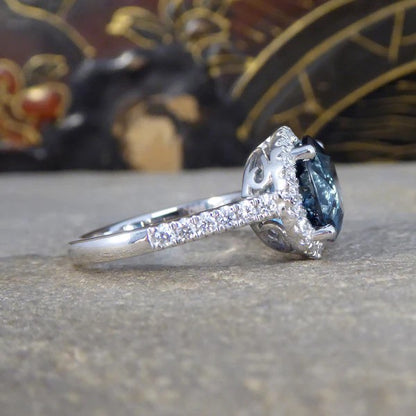 Halo cluster ring with London blue topaz and diamonds set in platinum.