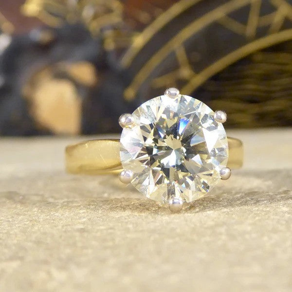 Solitaire diamond engagement ring in white and yellow gold.