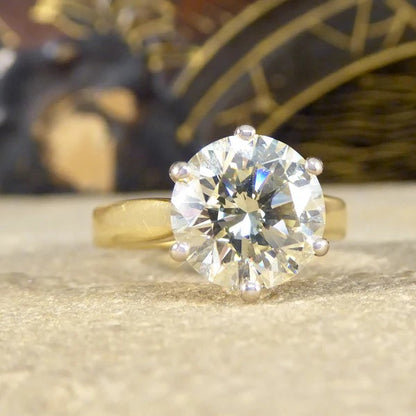 Solitaire diamond engagement ring in white and yellow gold.