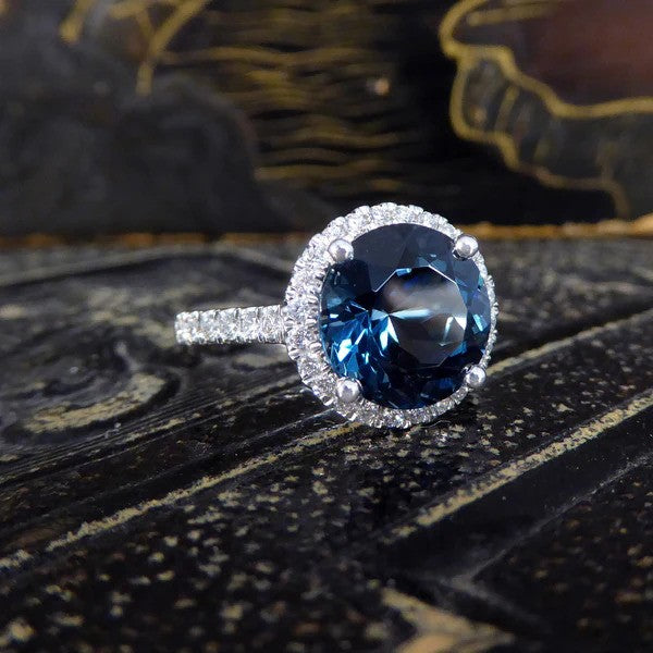 Halo cluster ring with London blue topaz and diamonds set in platinum.