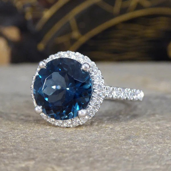 Halo cluster ring with London blue topaz and diamonds set in platinum.