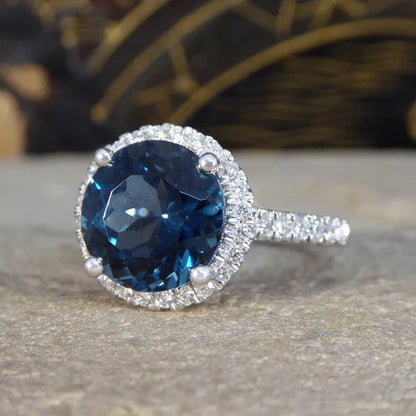 Halo cluster ring with London blue topaz and diamonds set in platinum.