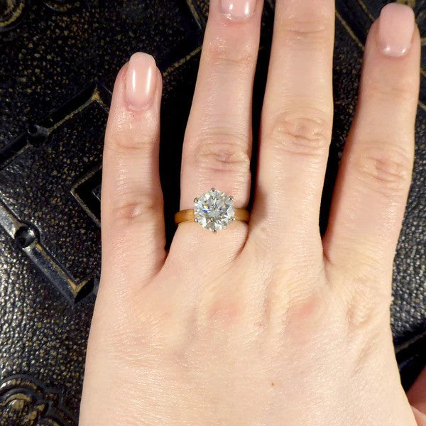 Solitaire diamond engagement ring in white and yellow gold.