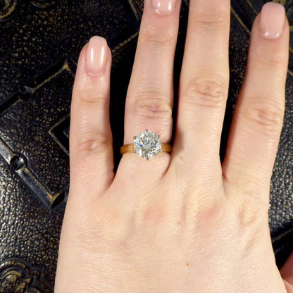 Solitaire diamond engagement ring in white and yellow gold.