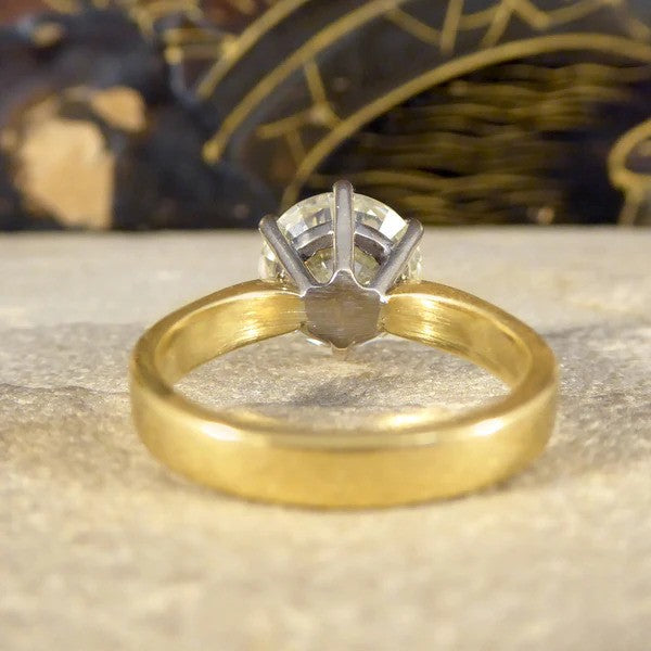 Solitaire diamond engagement ring in white and yellow gold.