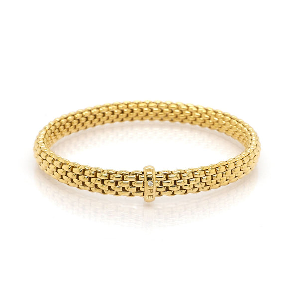 A yellow gold brick link bracelet with a diamond set clasp