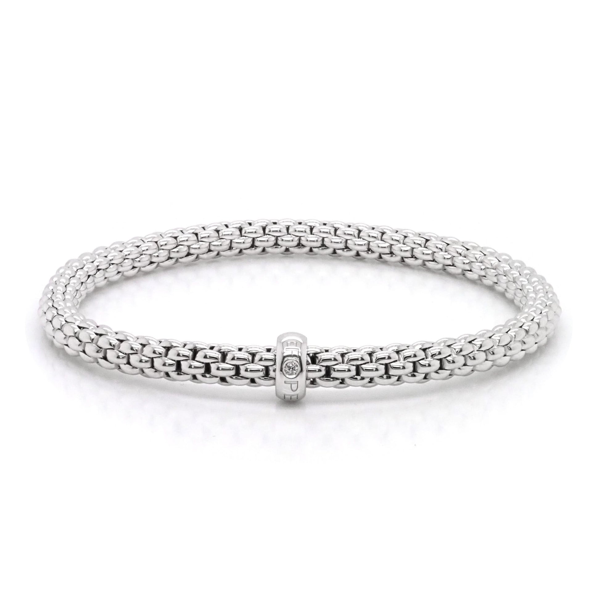A flexible white gold bracelet with a diamond set rondel marked FOPE