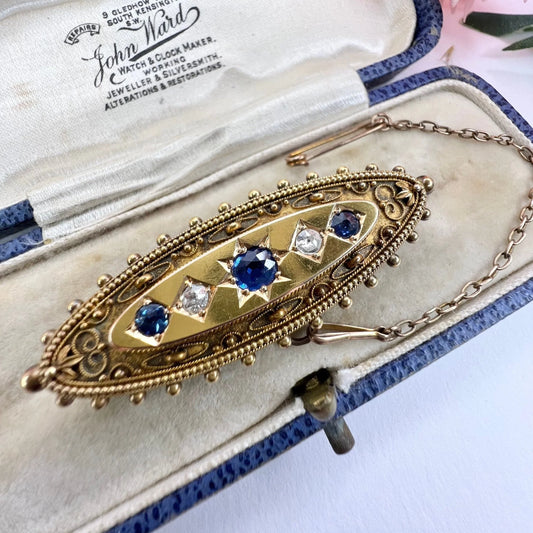 An antique yellow gold boat shaped brooch with sapphires and diamonds