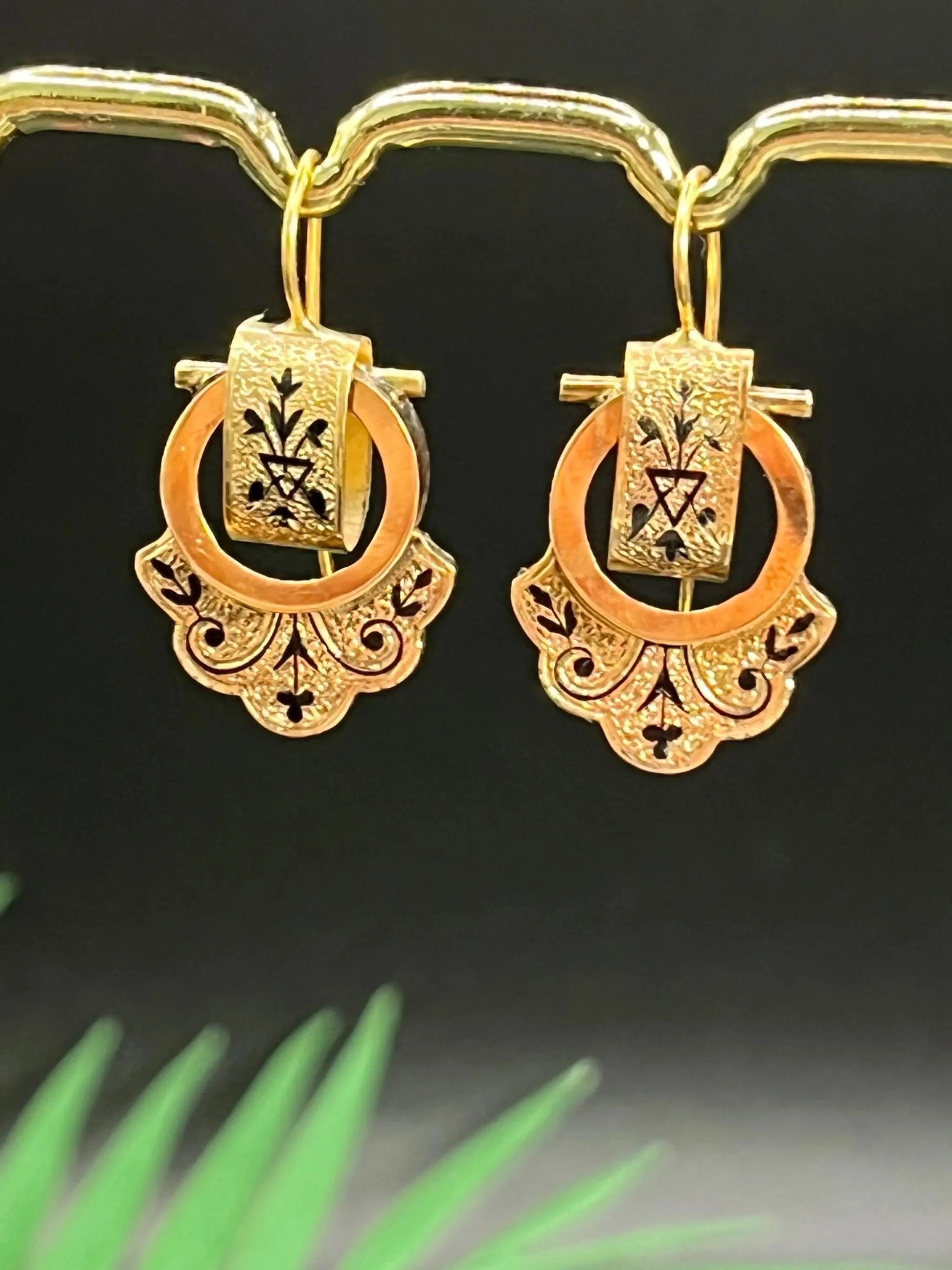 A pair of yellow gold and black enamel drop earrings